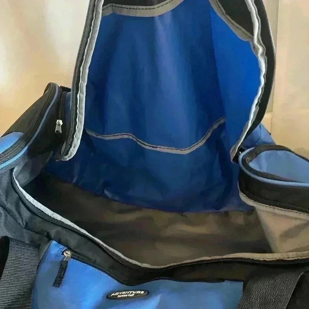 Adventure brand cargo travel‎ bag 30”L with several zipper pockets and wheels